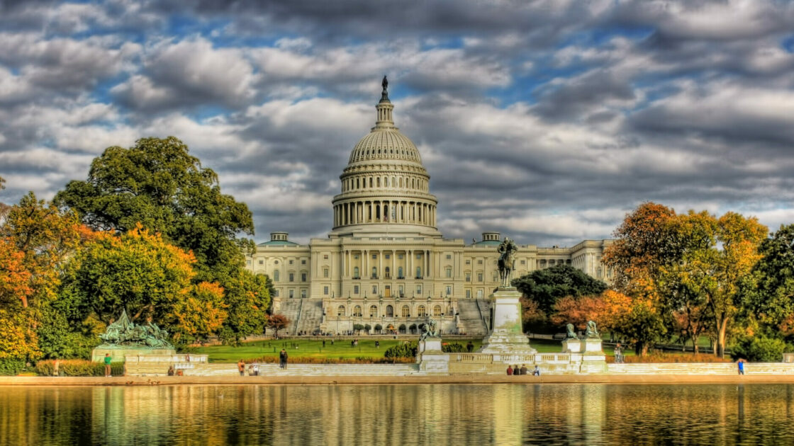Photo of U.S. Capitol building with reflecting pool in foreground.